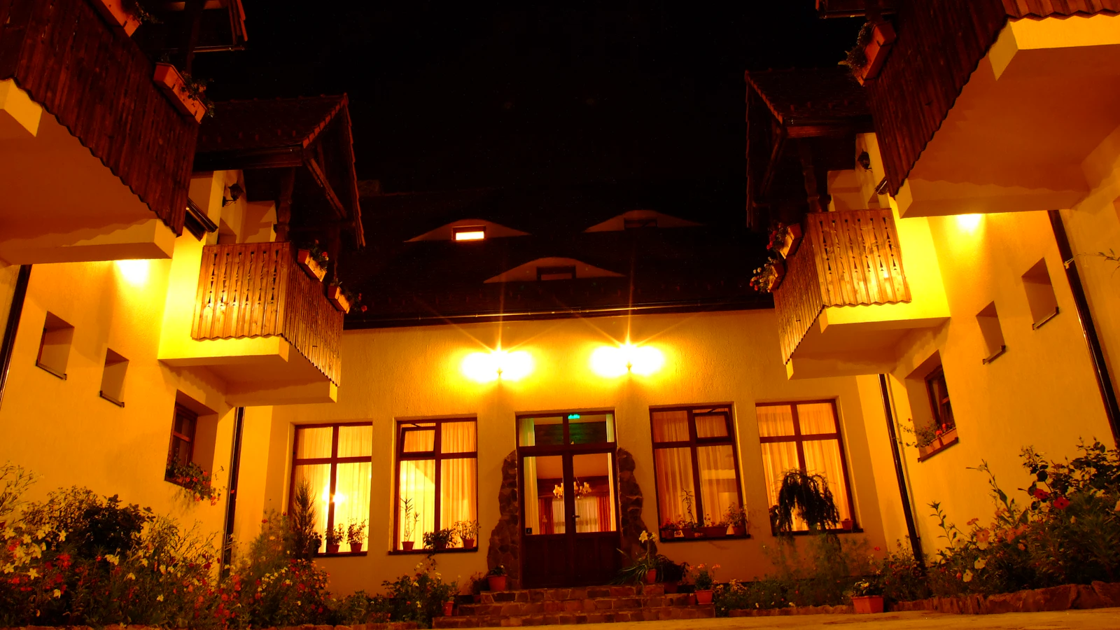 A guesthouse seen through a phone's map screen with a pin on the building at dusk