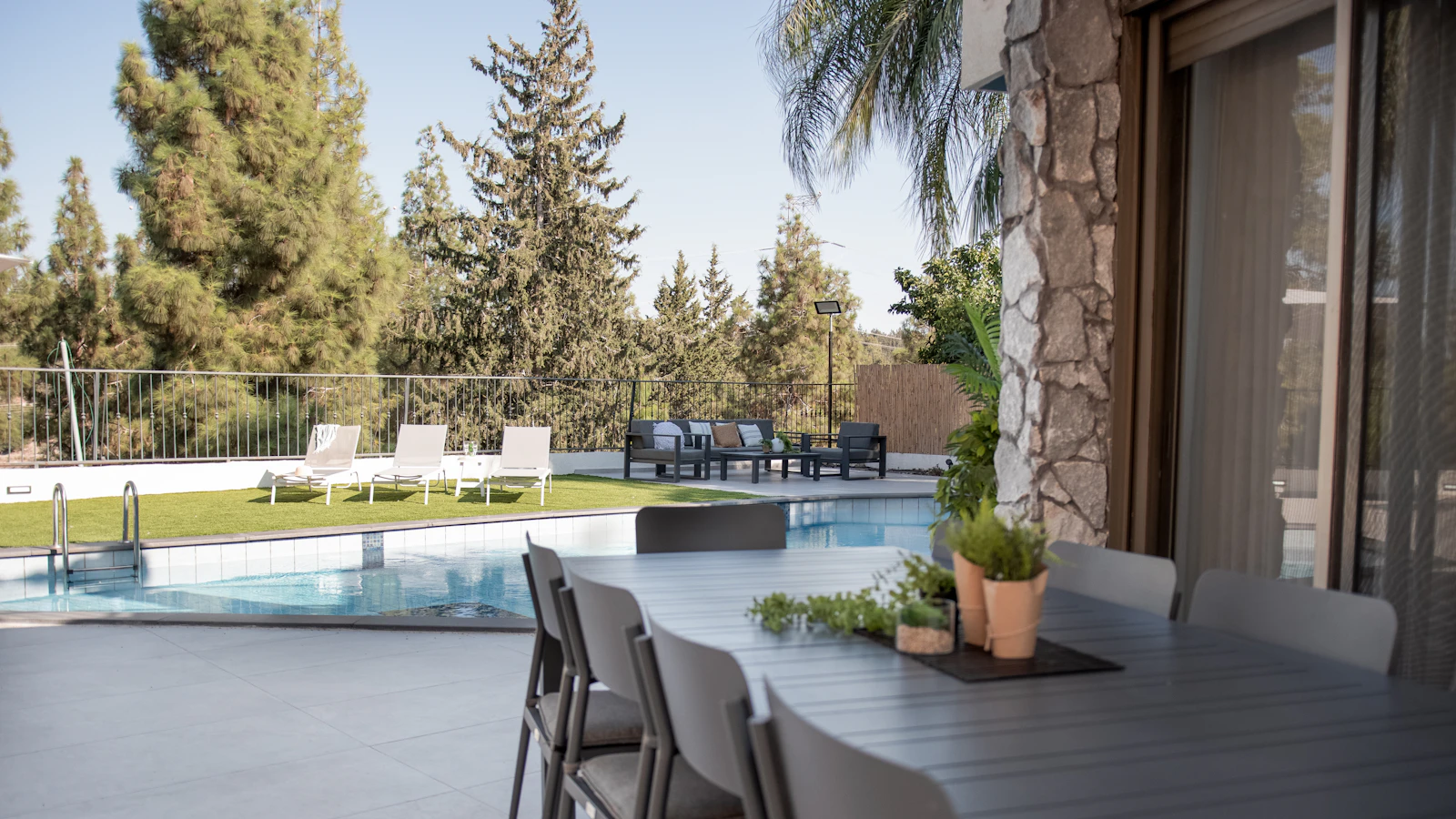 A proposal folder left on a garden table beside an unfinished pool outline as evening falls